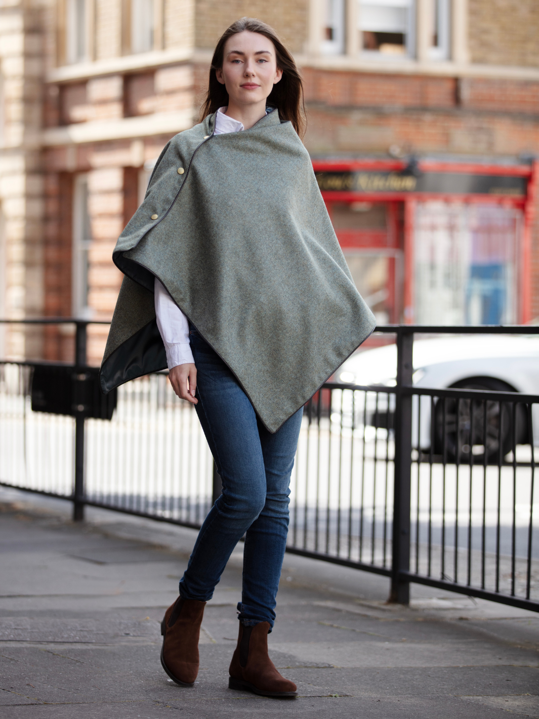 Green herringbone tweed shawl with burgundy satin lining, gold studs, and dark brown faux leather trim, made in the UK by John Partridge.