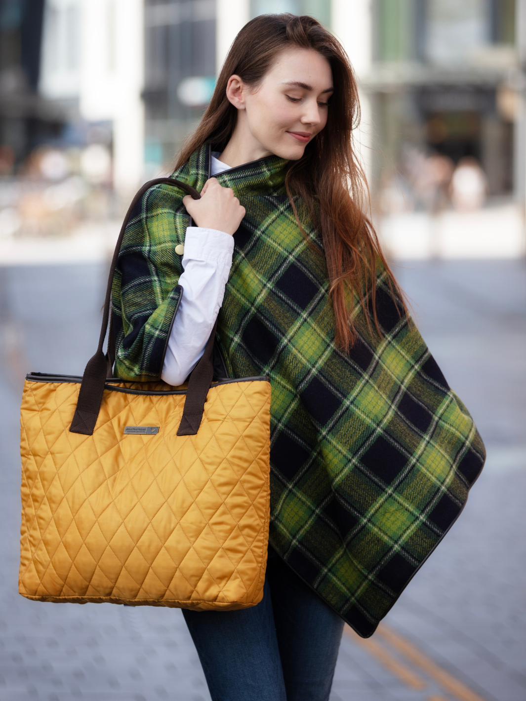 Green and black tartan tweed shawl with black satin lining, gold studs, and faux leather trim, handcrafted in the UK by John Partridge.