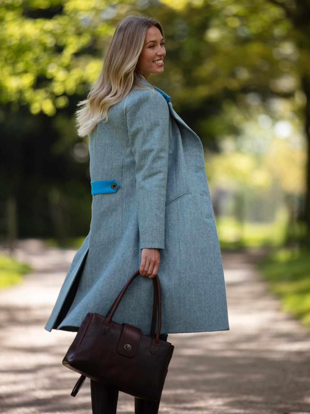 Pastel blue herringbone tweed coat with bright blue velvet cuffs and collar, knee-length, made in the UK by John Partridge.