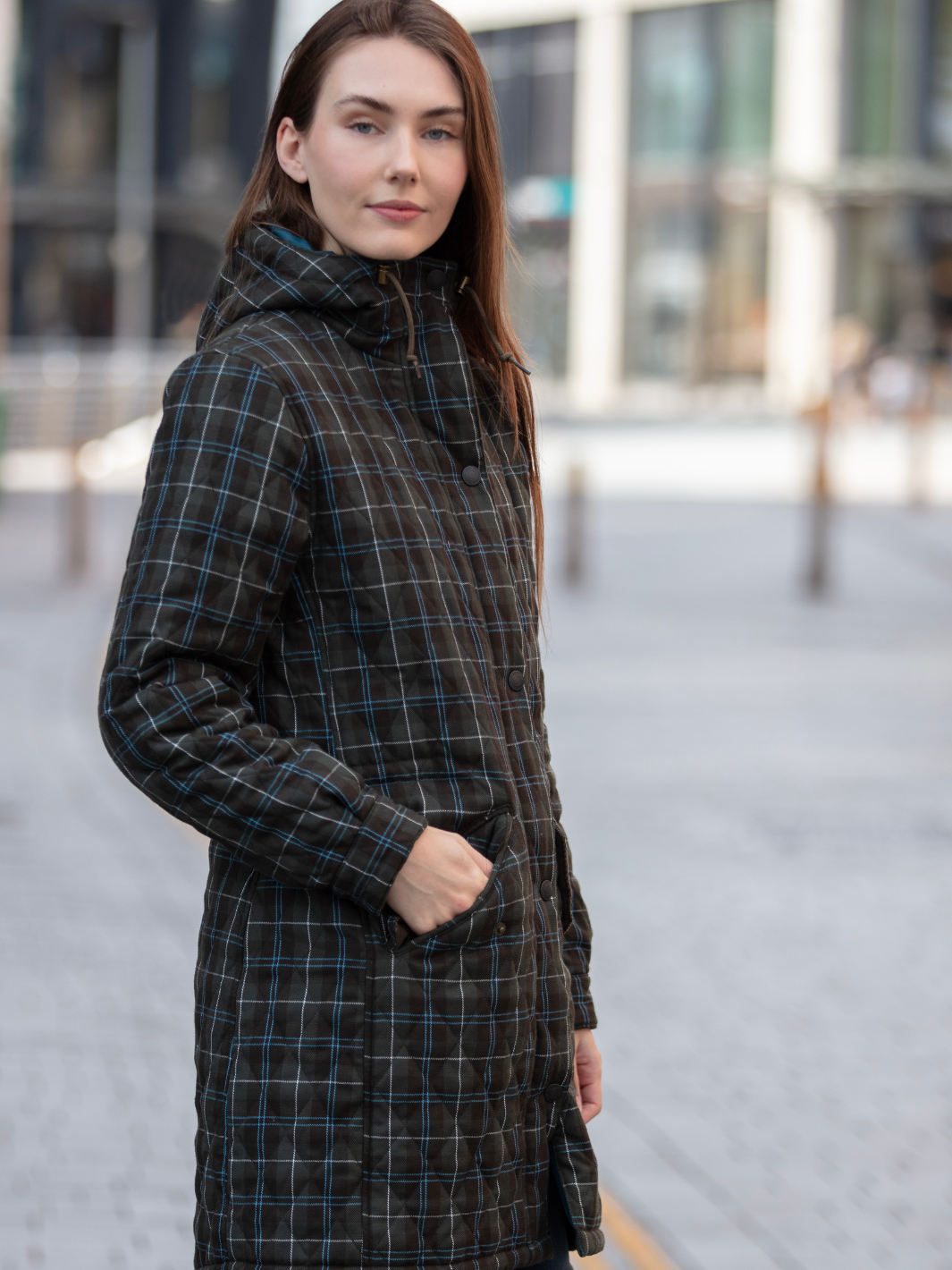 Newmarket Quilted Hooded Coat in Olive Check with adjustable waist and hood, olive corduroy trims, satin lining, 2-way zip, and practical pockets, crafted in Britain.