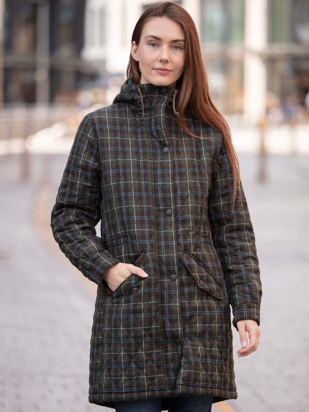 Newmarket Quilted Hooded Coat in Olive Check with adjustable waist and hood, olive corduroy trims, satin lining, 2-way zip, and practical pockets, crafted in Britain.