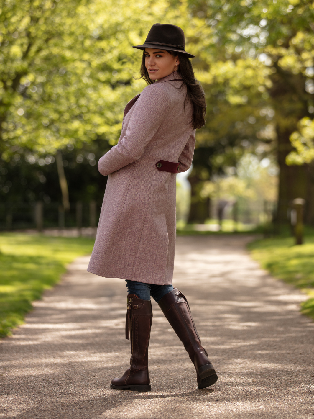 Pastel pink herringbone tweed coat with bright pink velvet cuffs and collar, knee-length, made in the UK by John Partridge.