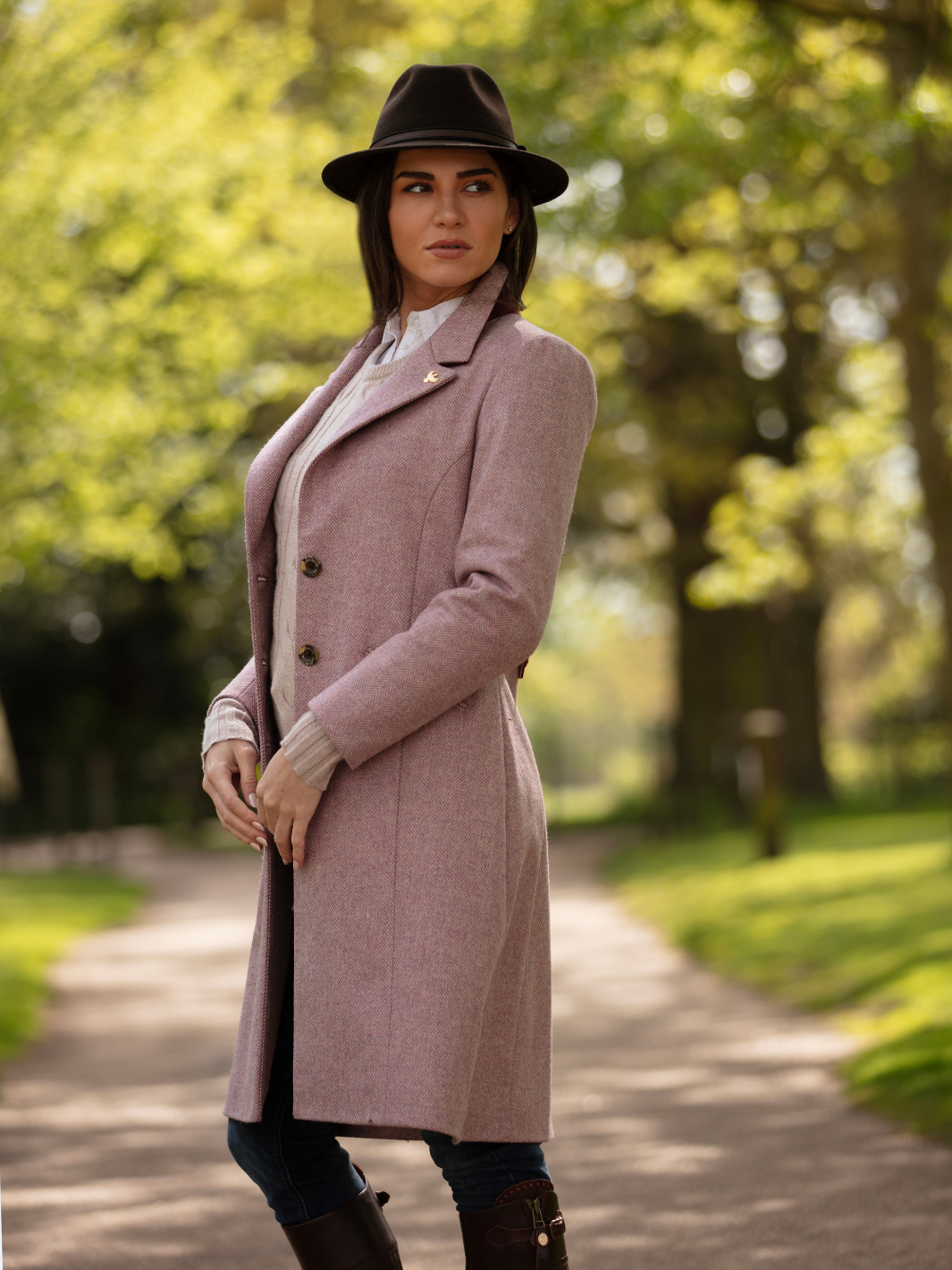 Pastel pink herringbone tweed coat with bright pink velvet cuffs and collar, knee-length, made in the UK by John Partridge.