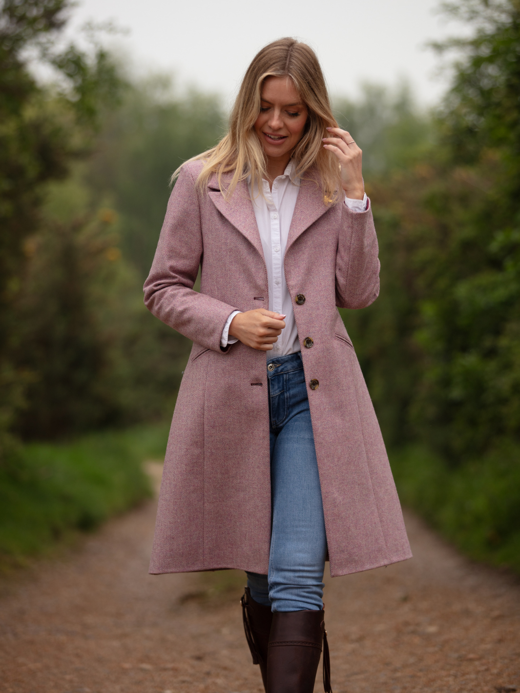 Pastel pink herringbone tweed coat with bright pink velvet cuffs and collar, knee-length, made in the UK by John Partridge.