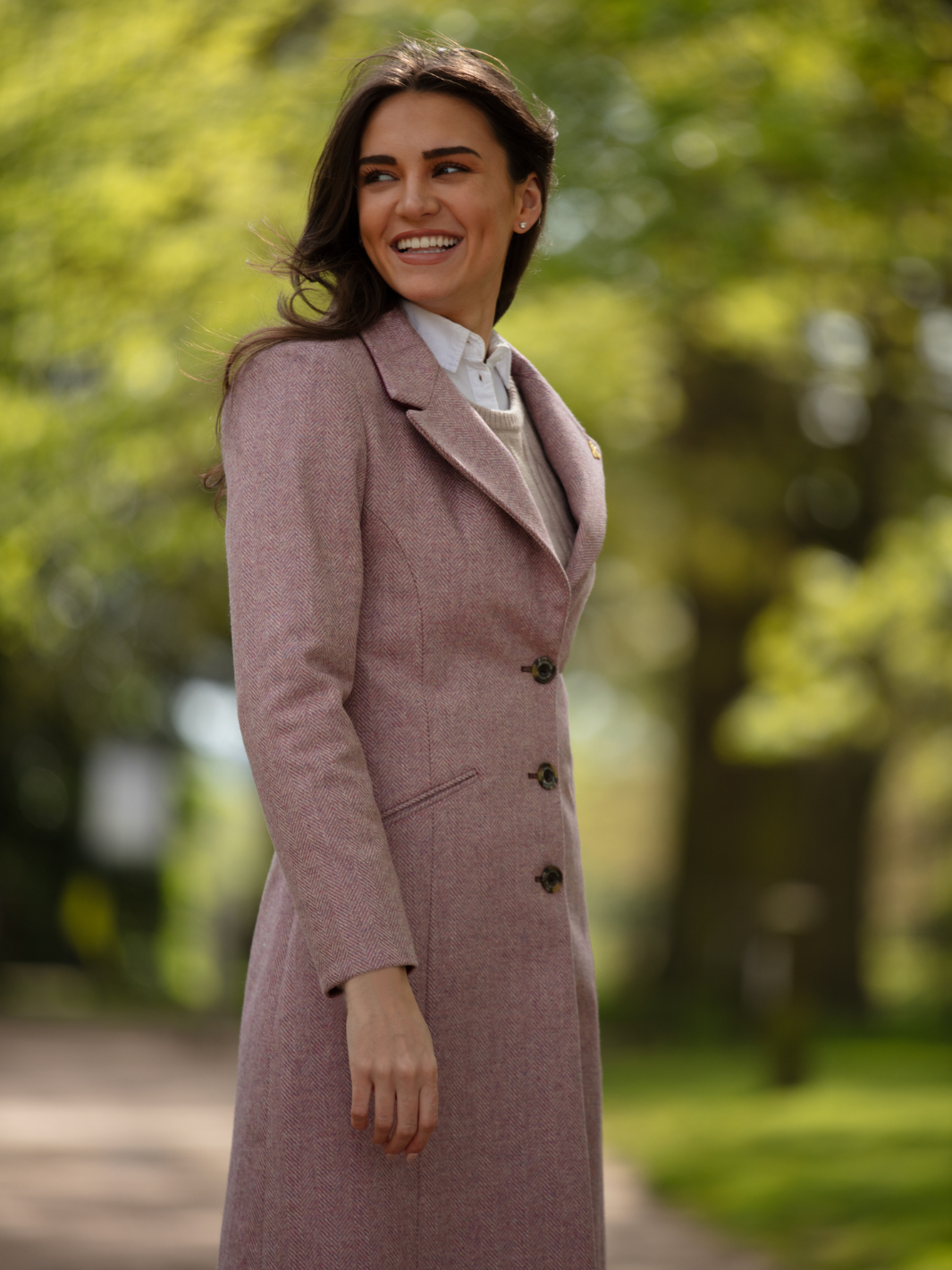 Pastel pink herringbone tweed coat with bright pink velvet cuffs and collar, knee-length, made in the UK by John Partridge.