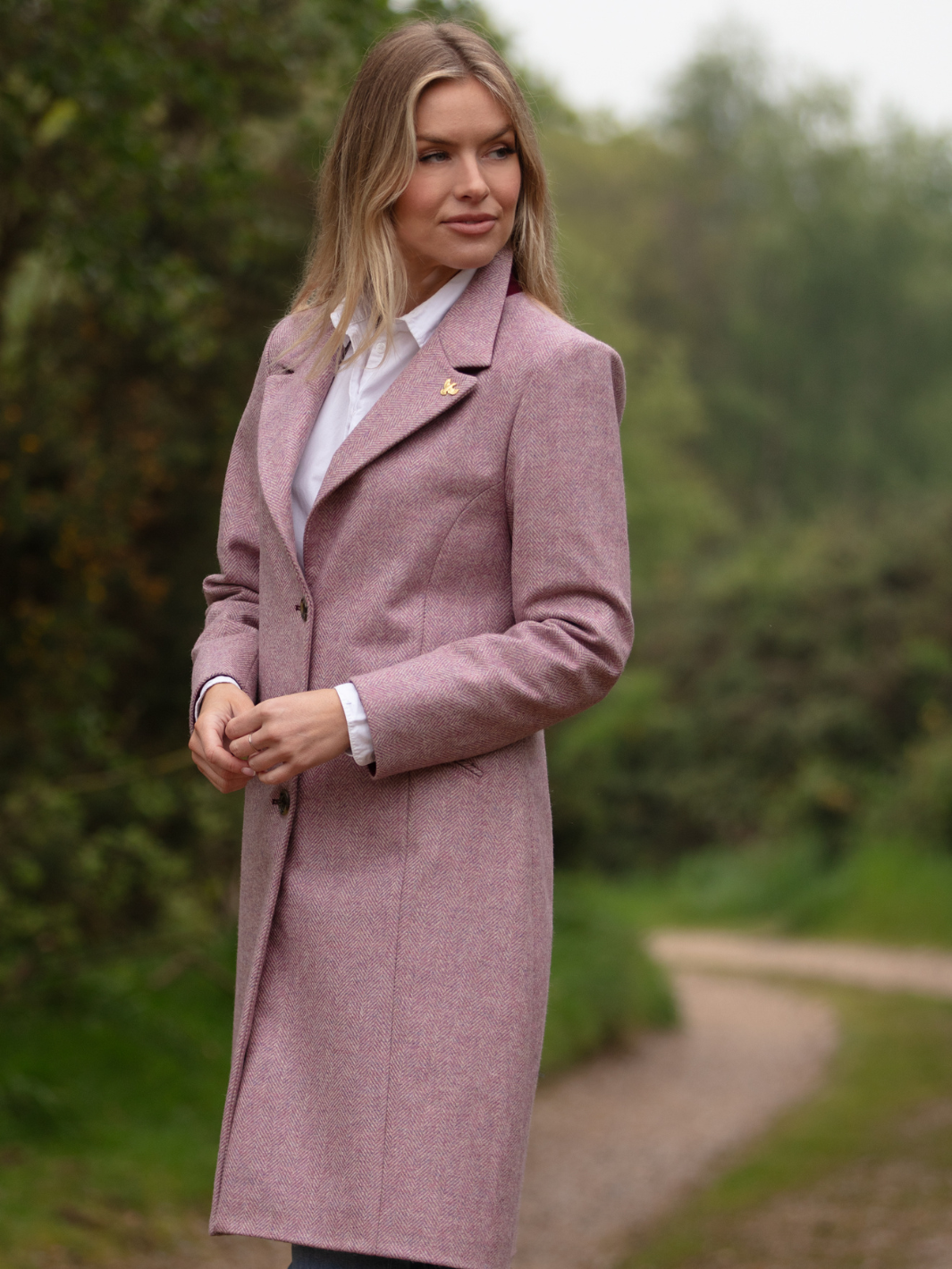 Pastel pink herringbone tweed coat with bright pink velvet cuffs and collar, knee-length, made in the UK by John Partridge.