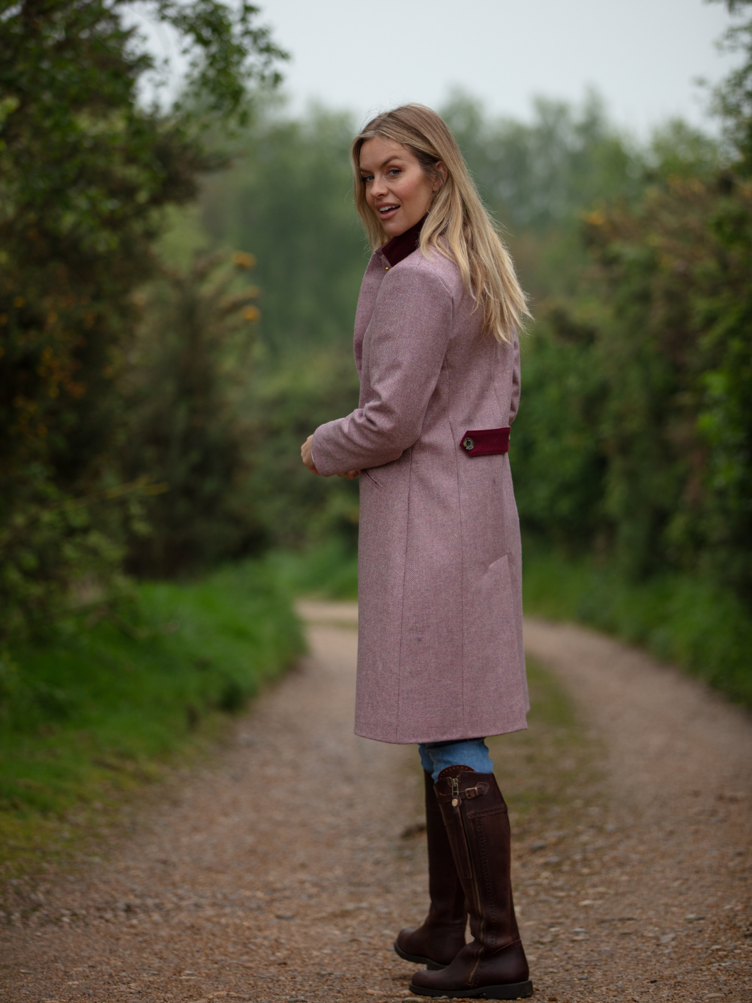 Pastel pink herringbone tweed coat with bright pink velvet cuffs and collar, knee-length, made in the UK by John Partridge.
