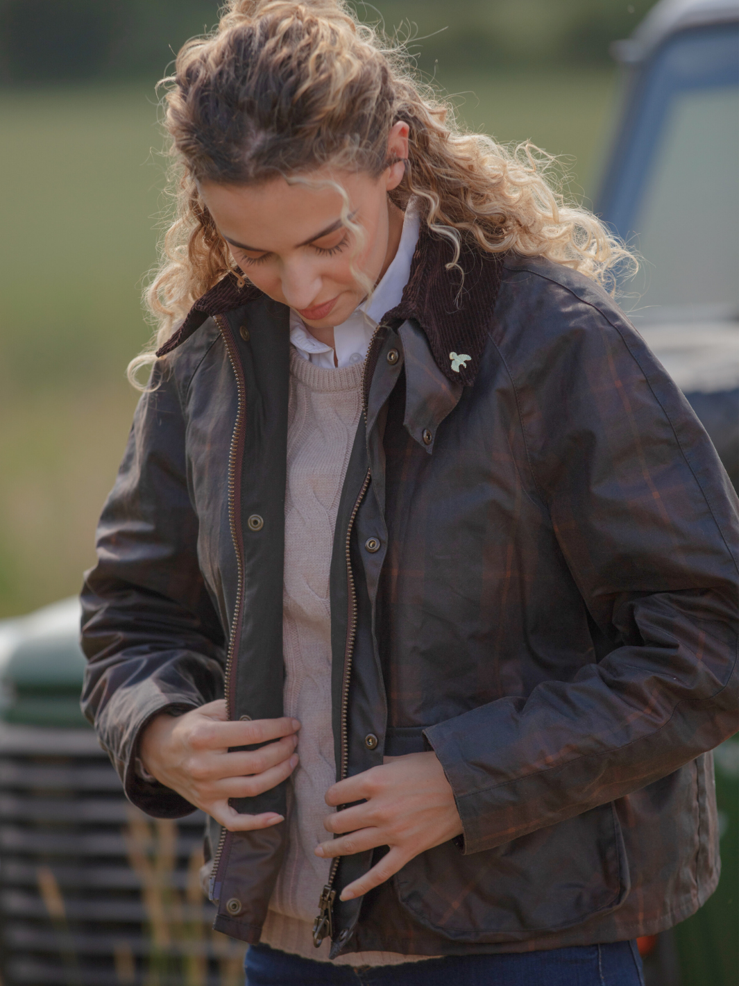 Landowner Short Wax Walking Jacket in Hunter Check with warm brown tones. A unisex, boxy-shaped waxed cotton jacket featuring cord and moleskin details for timeless elegance and weather protection, perfect for outdoor adventures or everyday wear.