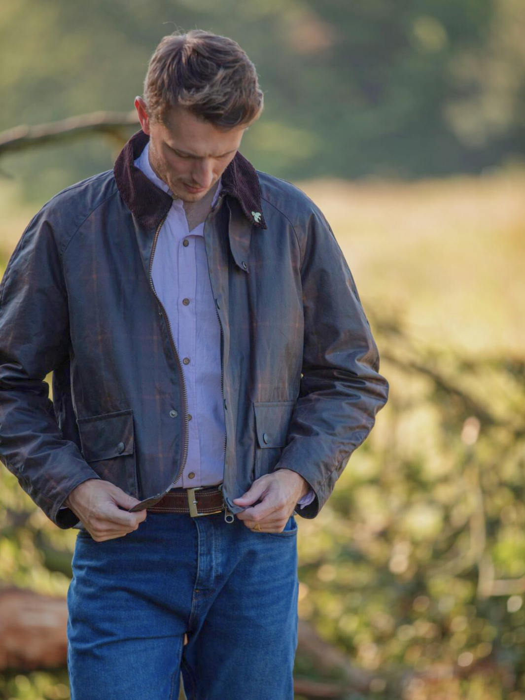 Landowner Short Wax Walking Jacket in Hunter Check with warm brown tones. A unisex, boxy-shaped waxed cotton jacket featuring cord and moleskin details for timeless elegance and weather protection, perfect for outdoor adventures or everyday wear.