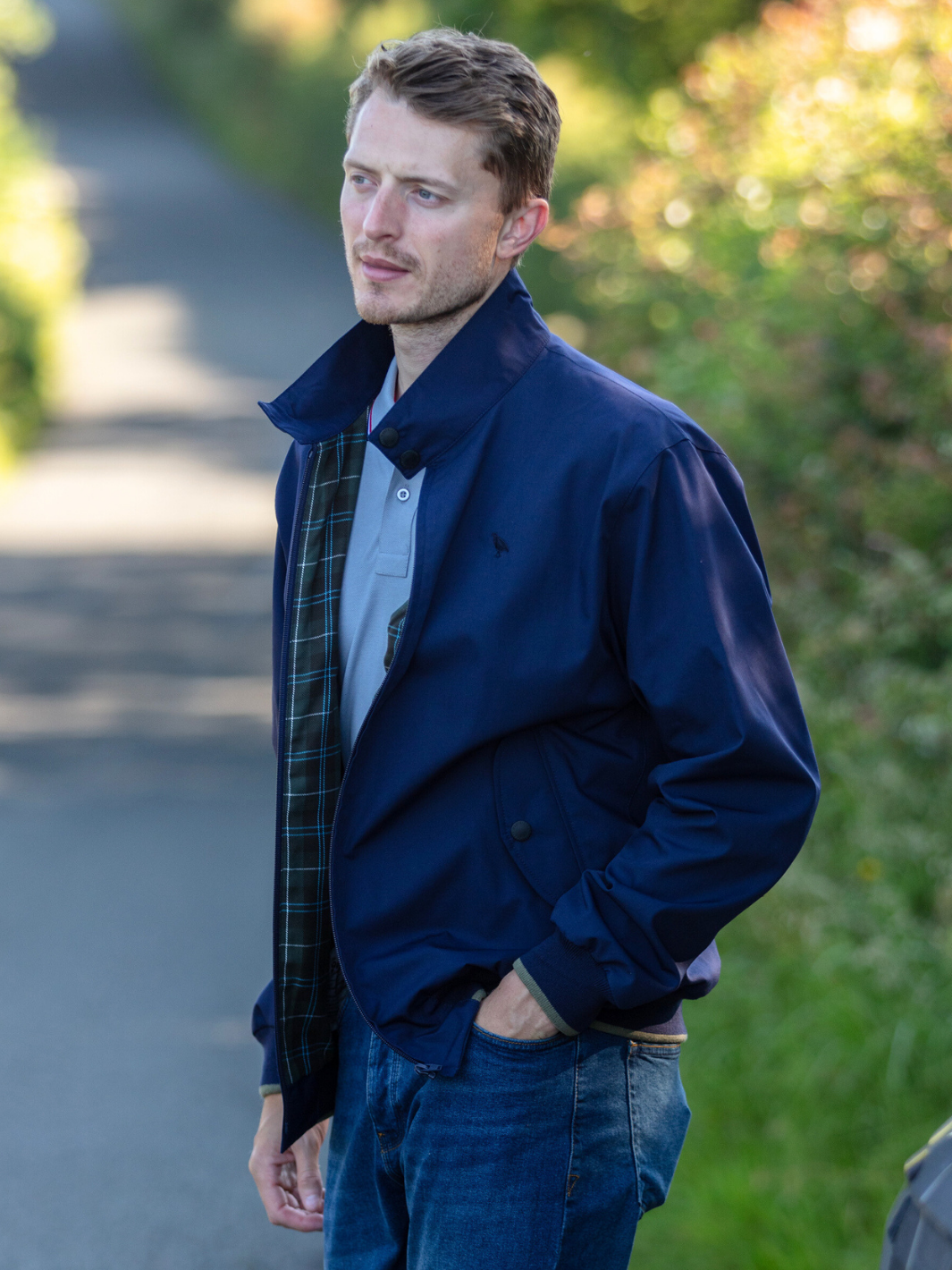 Men's Harrington Jacket in navy with zip front fastening, two front pockets, and olive check lining. Crafted in England, blending classic style, practicality, and superior craftsmanship for a versatile and refined look.