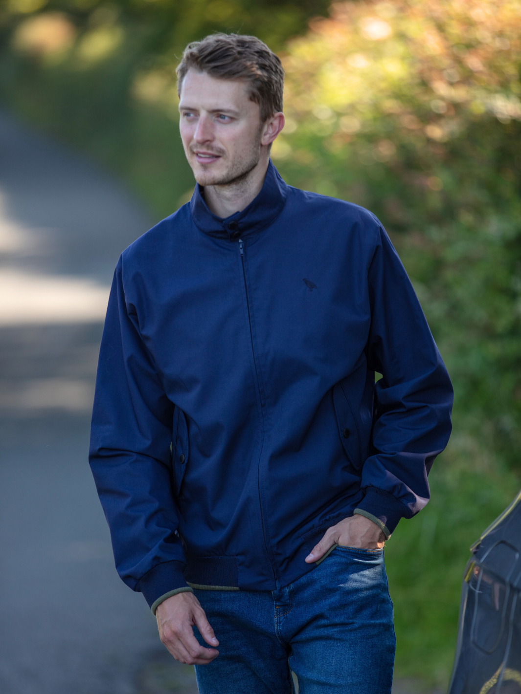 Men's Harrington Jacket in navy with zip front fastening, two front pockets, and olive check lining. Crafted in England, blending classic style, practicality, and superior craftsmanship for a versatile and refined look.