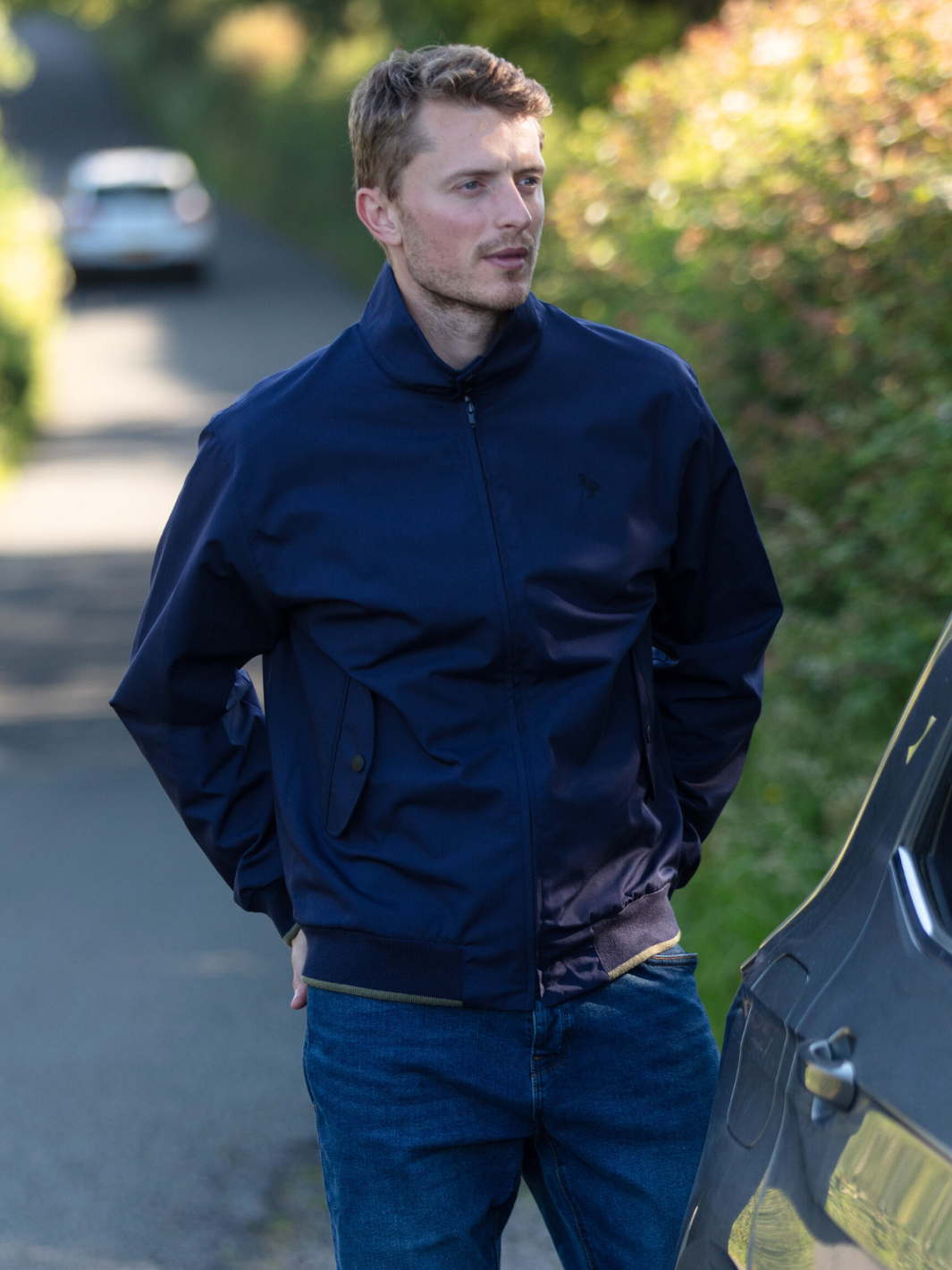 Men's Harrington Jacket in navy with zip front fastening, two front pockets, and olive check lining. Crafted in England, blending classic style, practicality, and superior craftsmanship for a versatile and refined look.