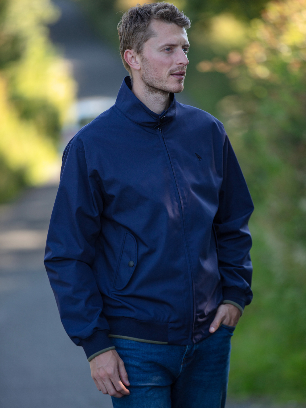 Men's Harrington Jacket in navy with zip front fastening, two front pockets, and olive check lining. Crafted in England, blending classic style, practicality, and superior craftsmanship for a versatile and refined look.