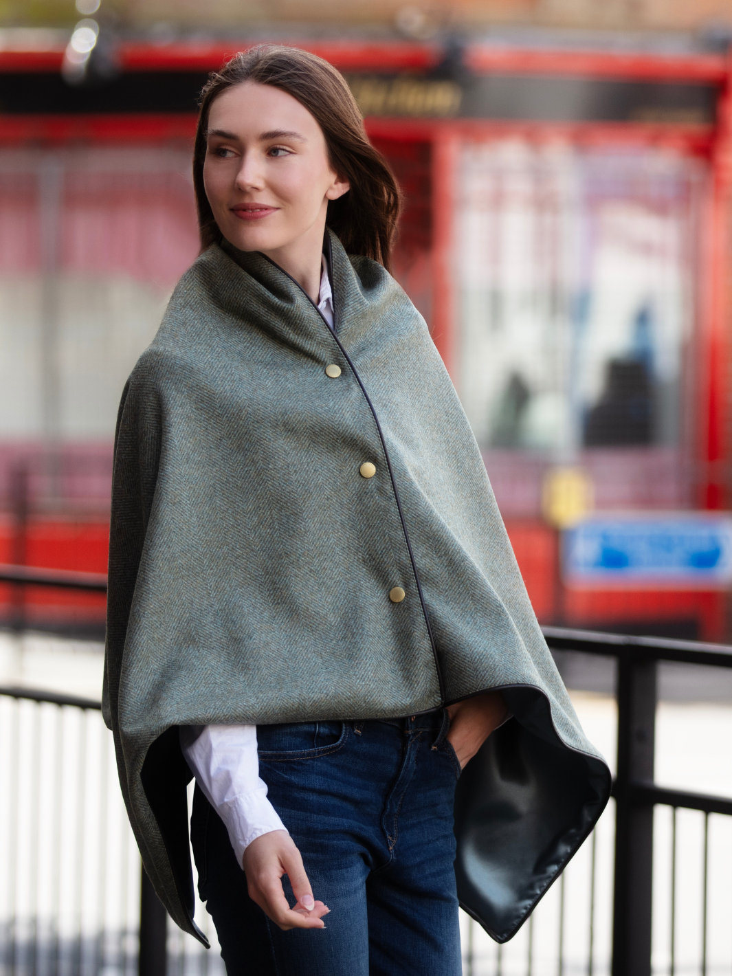 Green herringbone tweed shawl with burgundy satin lining, gold studs, and dark brown faux leather trim, made in the UK by John Partridge.