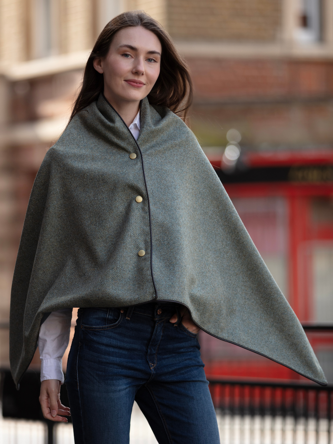 Green herringbone tweed shawl with burgundy satin lining, gold studs, and dark brown faux leather trim, made in the UK by John Partridge.