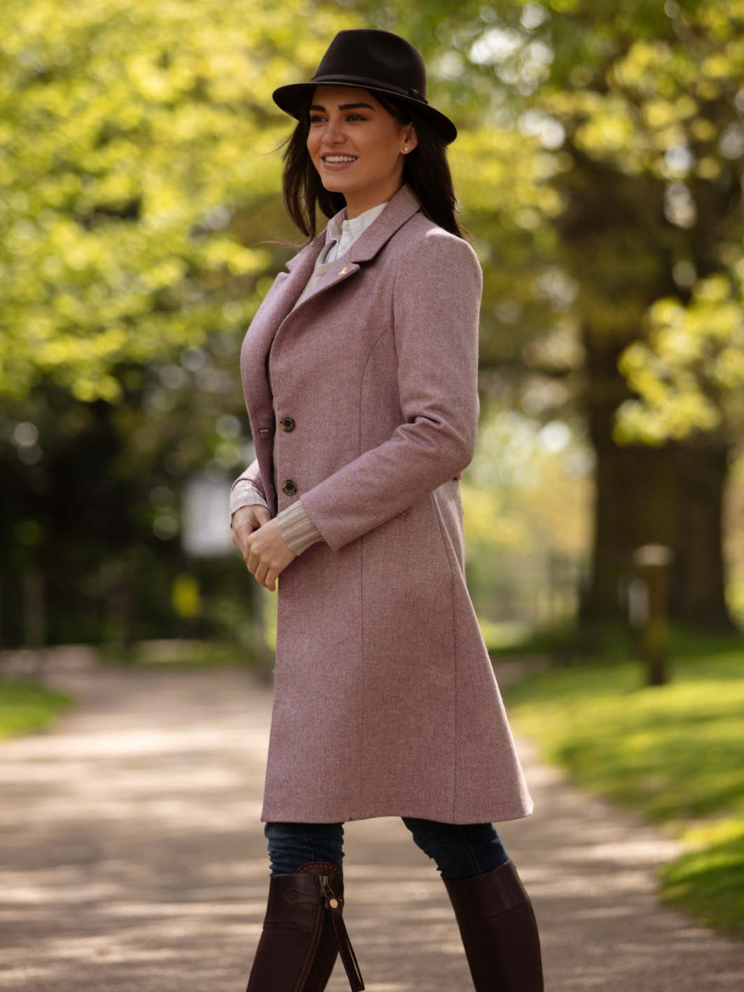 Pastel pink herringbone tweed coat with bright pink velvet cuffs and collar, knee-length, made in the UK by John Partridge.
