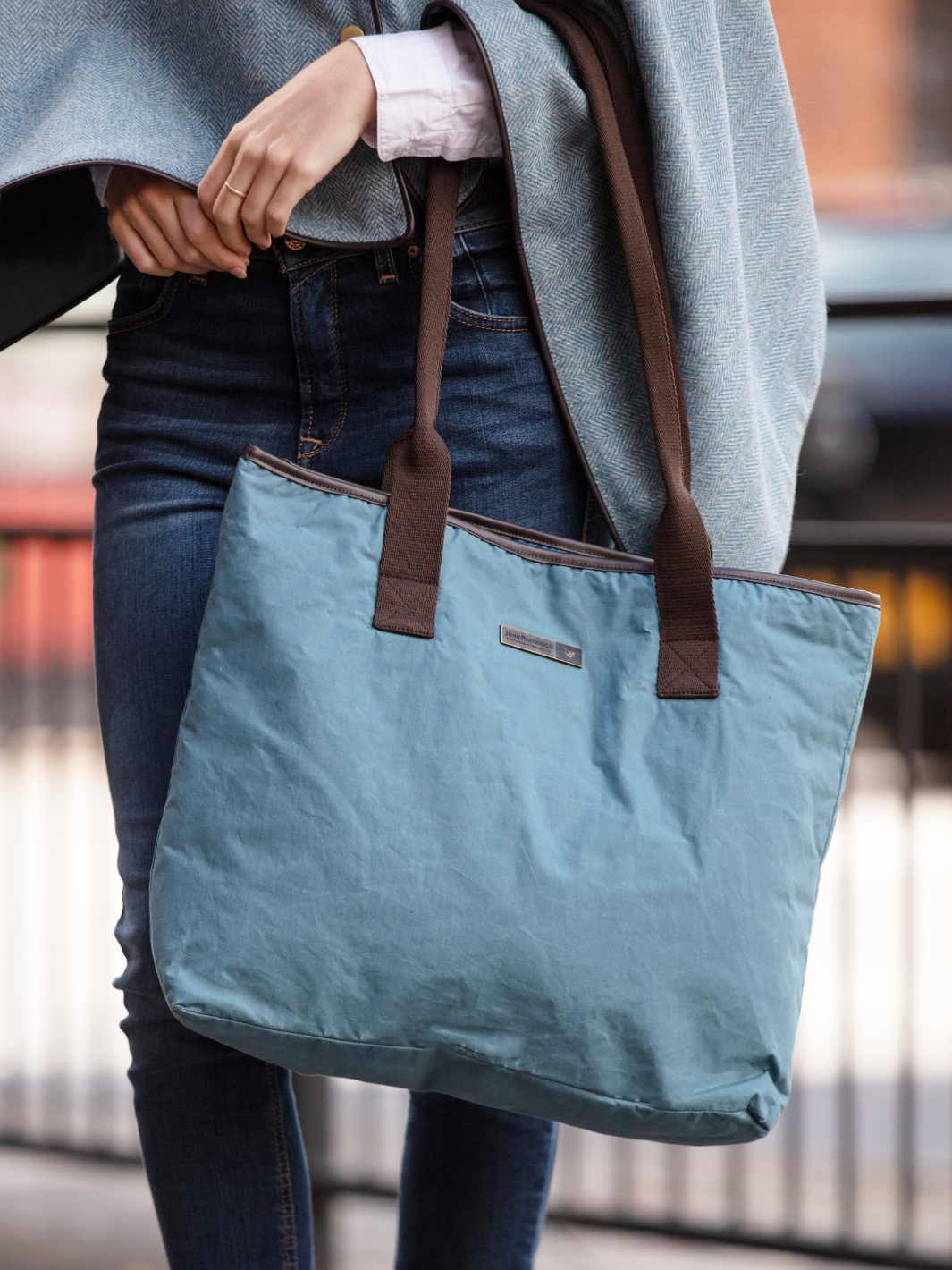 John Partridge & Co. Oversized Tote Bag in teal with herringbone straps, leather-look binding, antique brass plate, and spacious interior, expertly crafted in England.