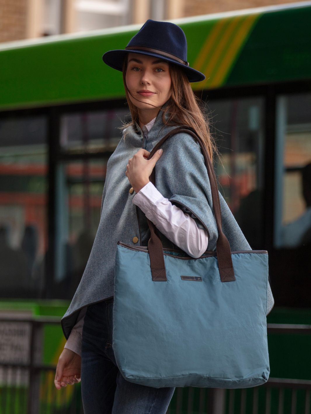 John Partridge & Co. Oversized Tote Bag in teal with herringbone straps, leather-look binding, antique brass plate, and spacious interior, expertly crafted in England.