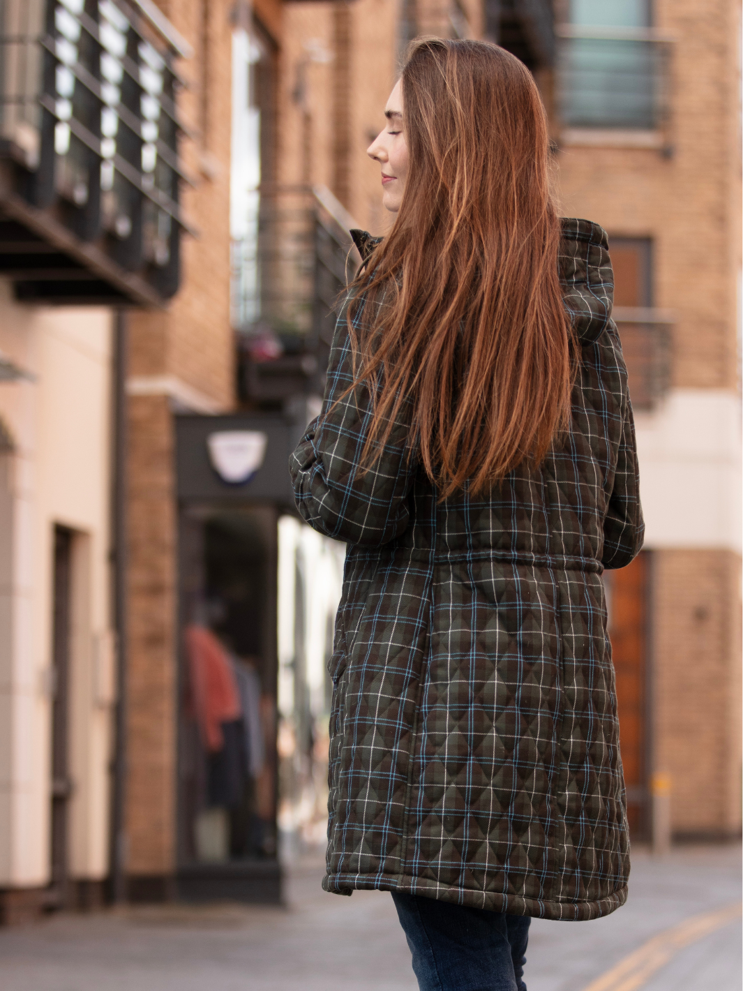 Newmarket Quilted Hooded Coat in Olive Check with adjustable waist and hood, olive corduroy trims, satin lining, 2-way zip, and practical pockets, crafted in Britain.