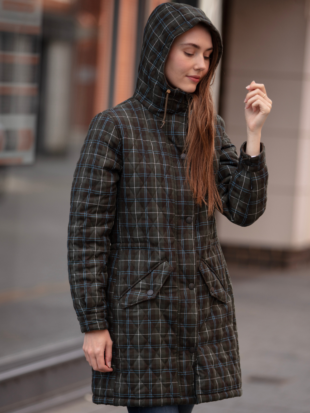 Newmarket Quilted Hooded Coat in Olive Check with adjustable waist and hood, olive corduroy trims, satin lining, 2-way zip, and practical pockets, crafted in Britain.