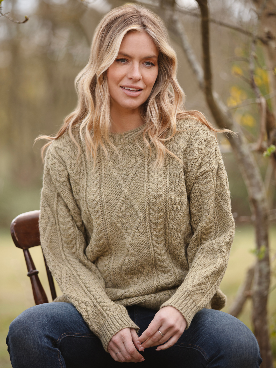 Unisex Aran Wool Jumper - Warm Stone | Women’s model wearing a breathable British wool jumper with classic textured stitching