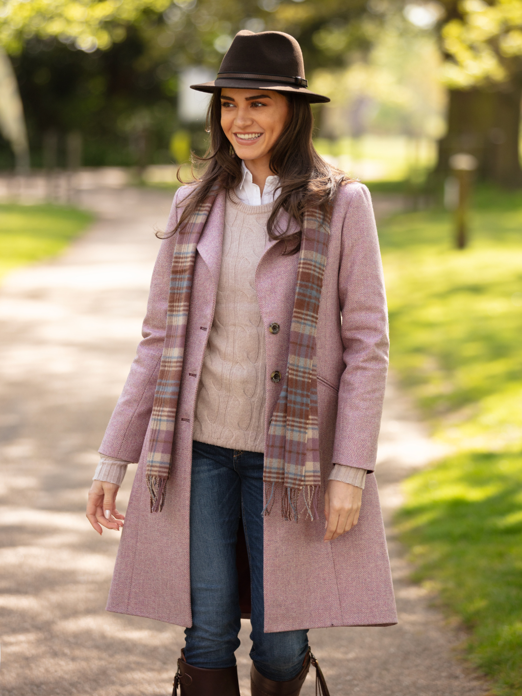 Pastel pink herringbone tweed coat with bright pink velvet cuffs and collar, knee-length, made in the UK by John Partridge.
