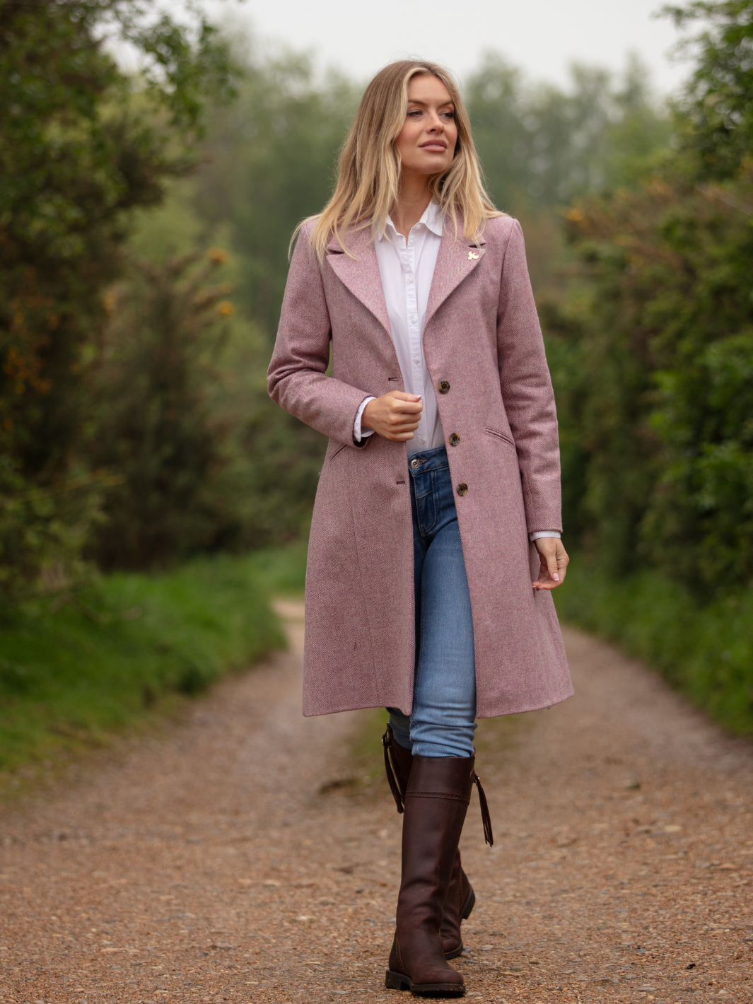 Pastel pink herringbone tweed coat with bright pink velvet cuffs and collar, knee-length, made in the UK by John Partridge.