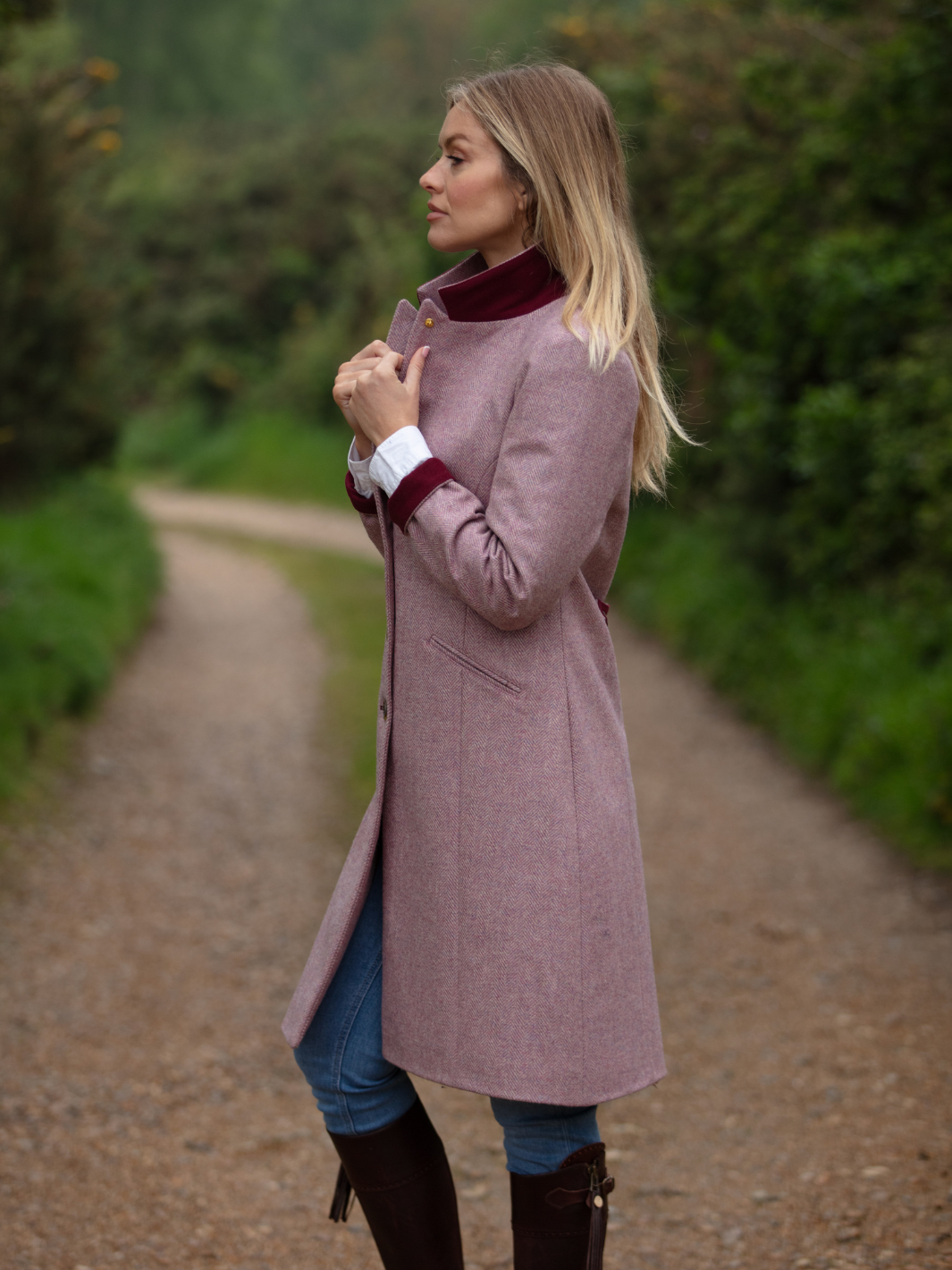Pastel pink herringbone tweed coat with bright pink velvet cuffs and collar, knee-length, made in the UK by John Partridge.
