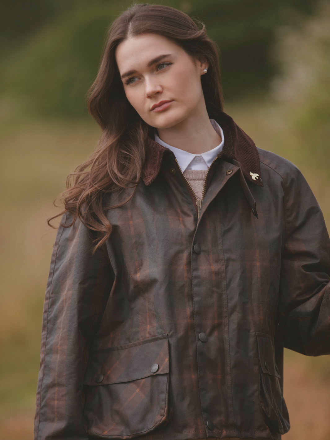 Landowner Short Wax Walking Jacket in Hunter Check with warm brown tones. A unisex, boxy-shaped waxed cotton jacket featuring cord and moleskin details for timeless elegance and weather protection, perfect for outdoor adventures or everyday wear.