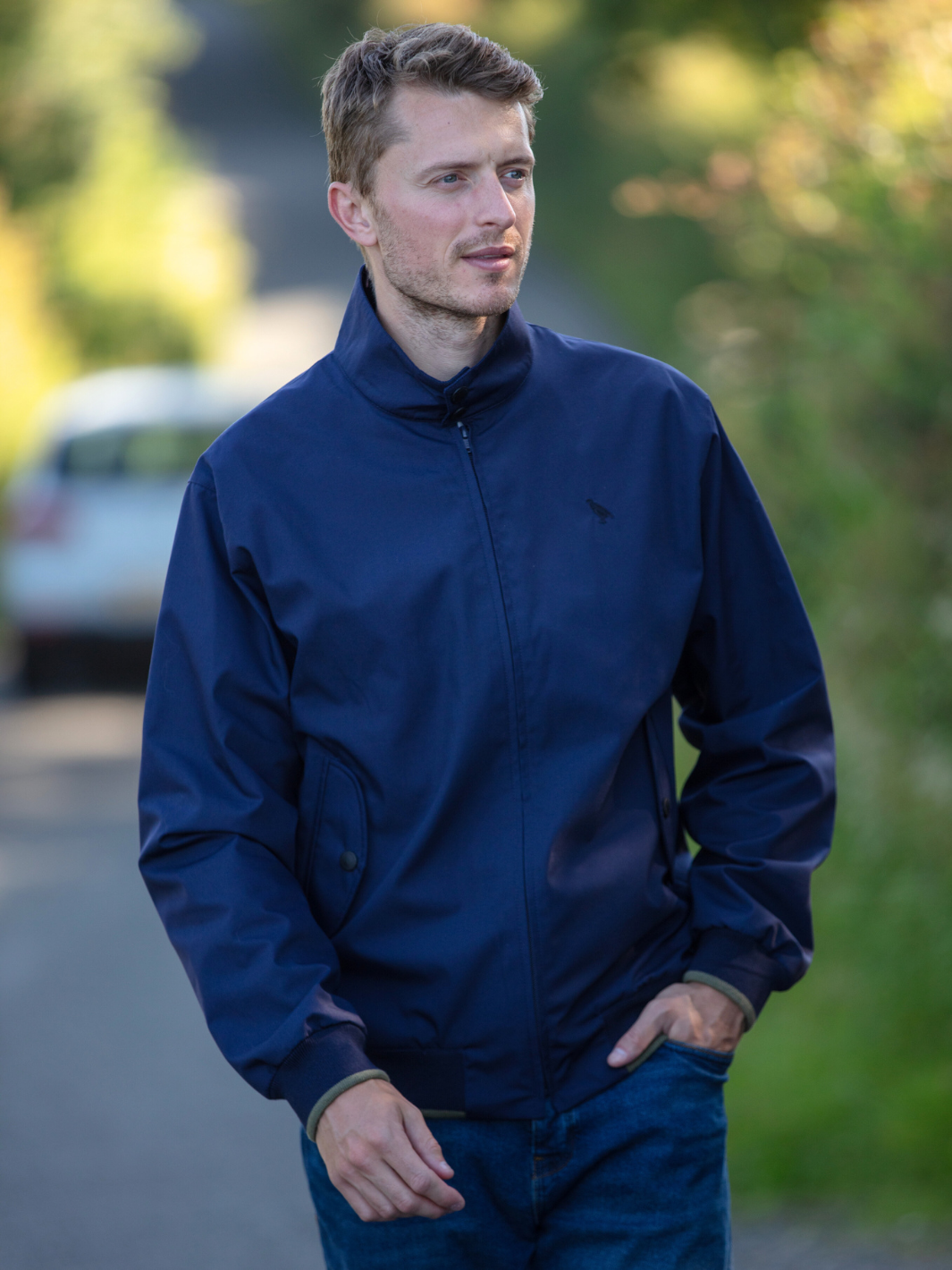 Men's Harrington Jacket in navy with zip front fastening, two front pockets, and olive check lining. Crafted in England, blending classic style, practicality, and superior craftsmanship for a versatile and refined look.