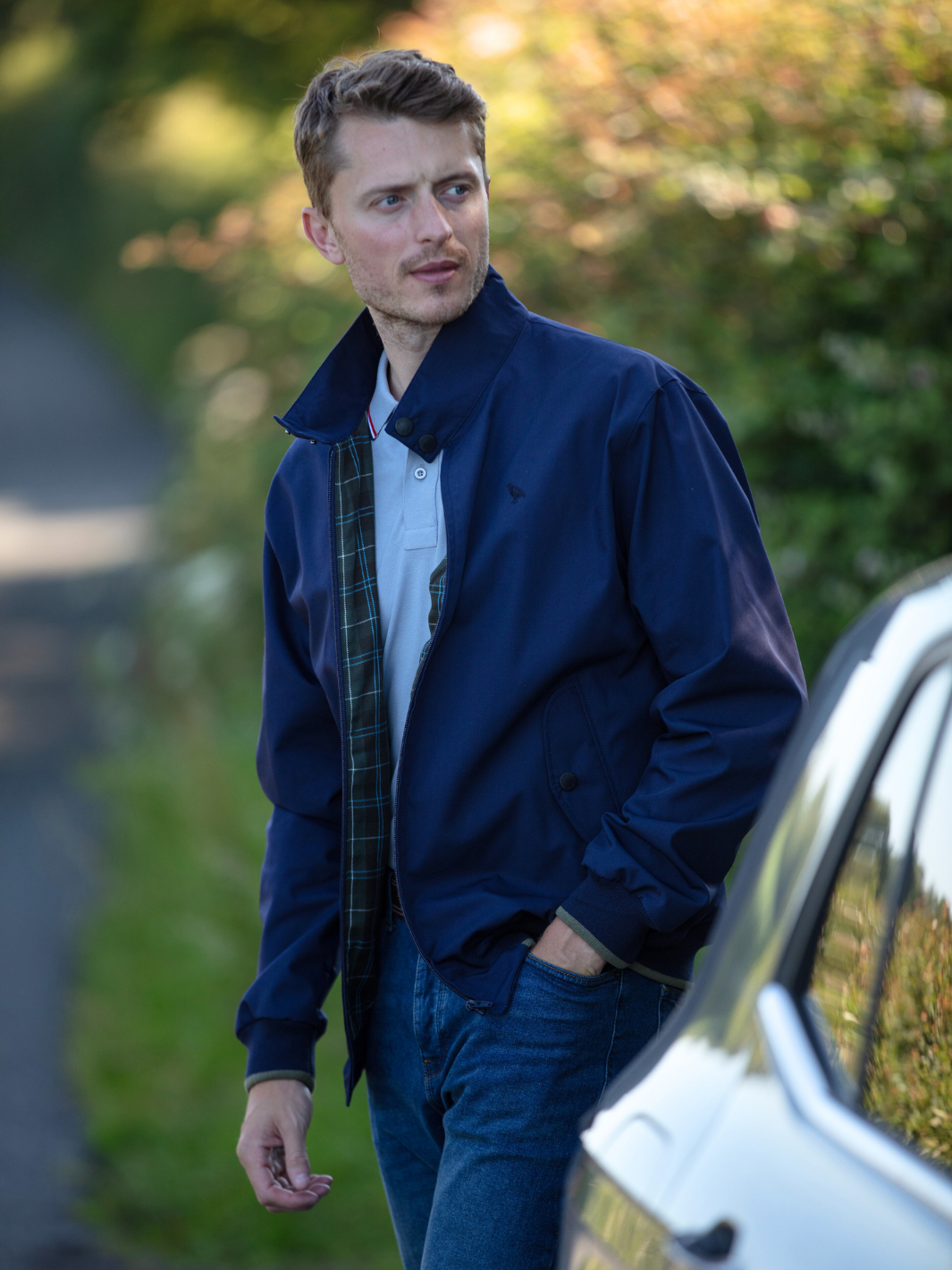 Men's Harrington Jacket in navy with zip front fastening, two front pockets, and olive check lining. Crafted in England, blending classic style, practicality, and superior craftsmanship for a versatile and refined look.