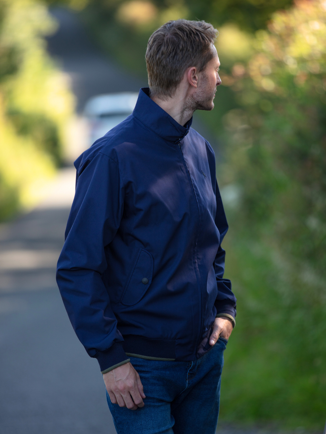 Men's Harrington Jacket in navy with zip front fastening, two front pockets, and olive check lining. Crafted in England, blending classic style, practicality, and superior craftsmanship for a versatile and refined look.