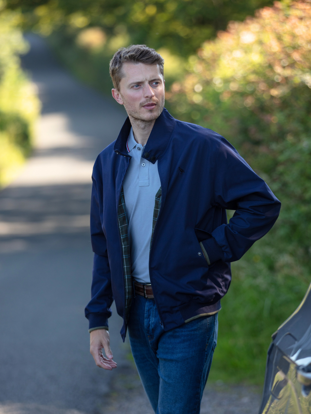 Men's Harrington Jacket in navy with zip front fastening, two front pockets, and olive check lining. Crafted in England, blending classic style, practicality, and superior craftsmanship for a versatile and refined look.
