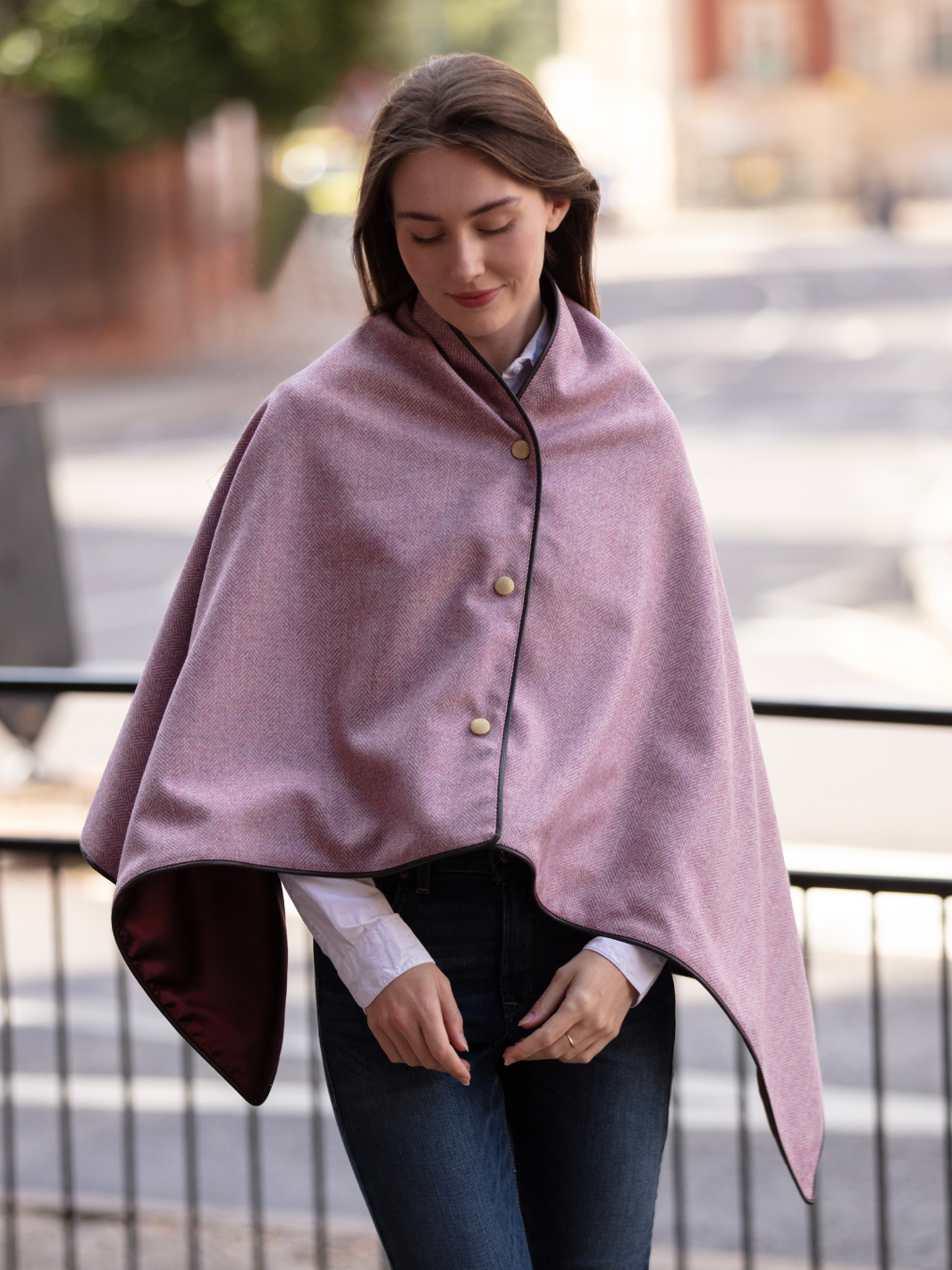 Soft pink herringbone tweed shawl with burgundy satin lining, gold studs, and dark brown faux leather trim, made in the UK by John Partridge.